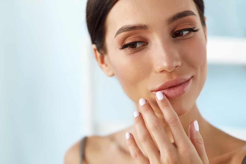 Young Woman Contemplating The Choice Between Botox Lip Flip And Lip Filler Treatments